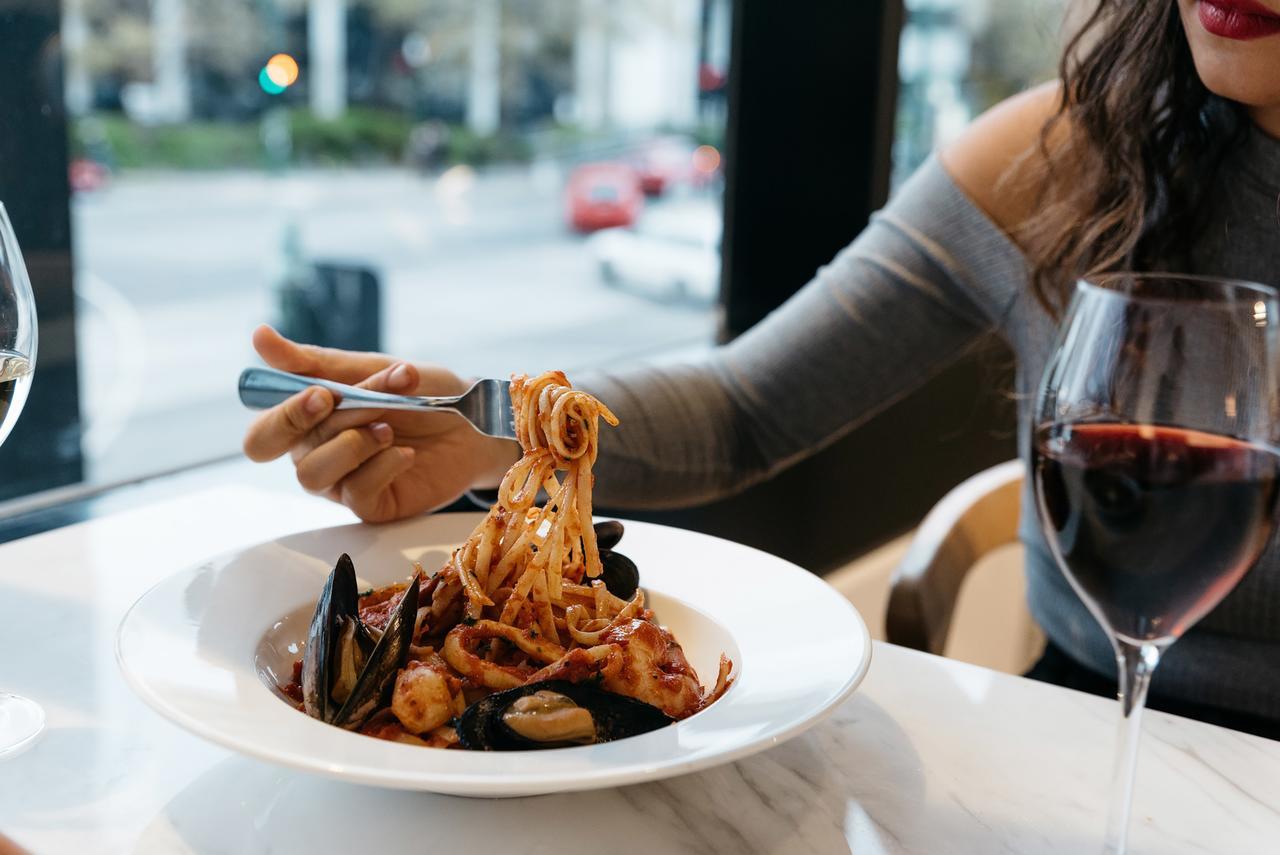 Art Series - The Chen Box Hill Exterior foto A woman eating a pasta dish